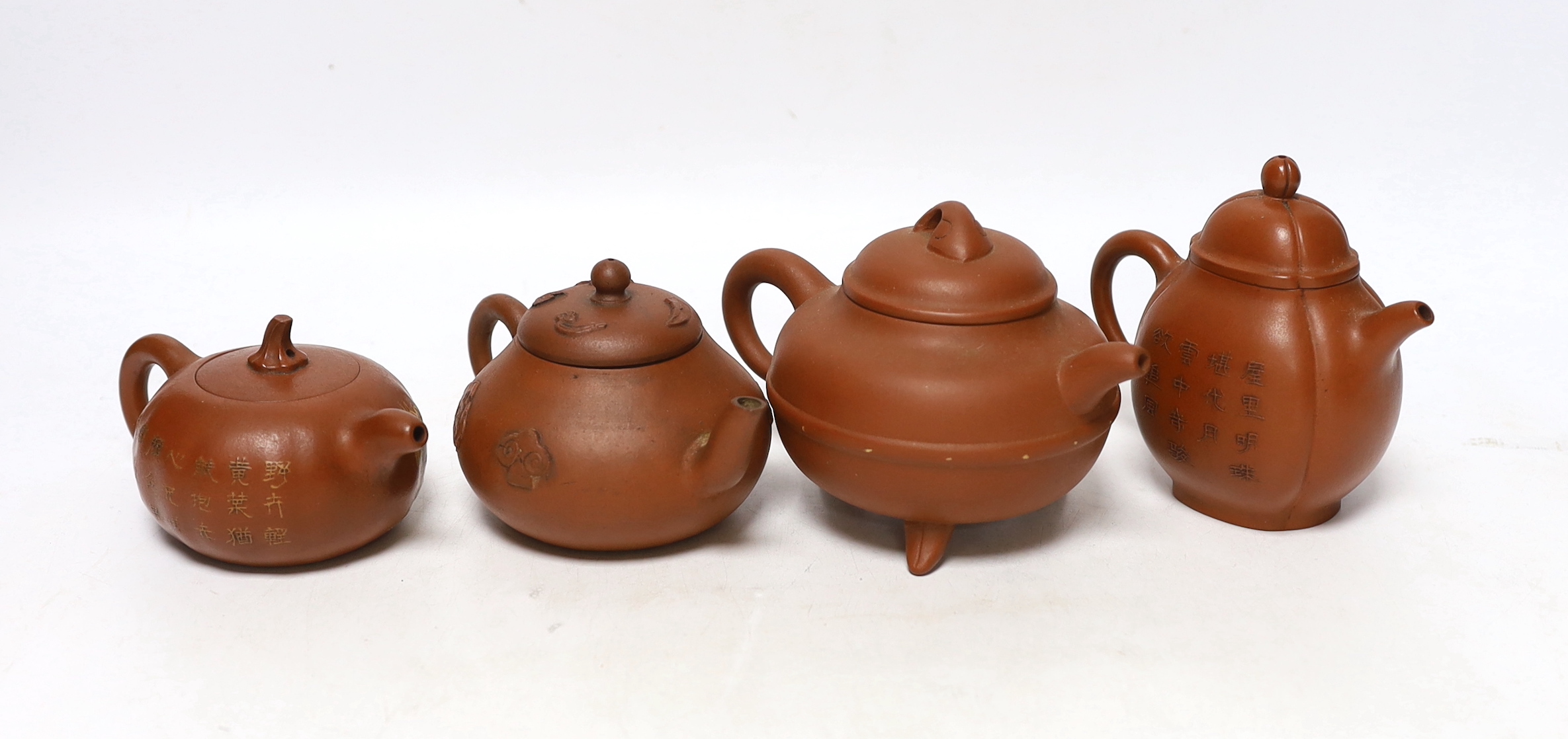Four Chinese Yixing teapots, one slip decorated with a landscape, tallest 10.5cm